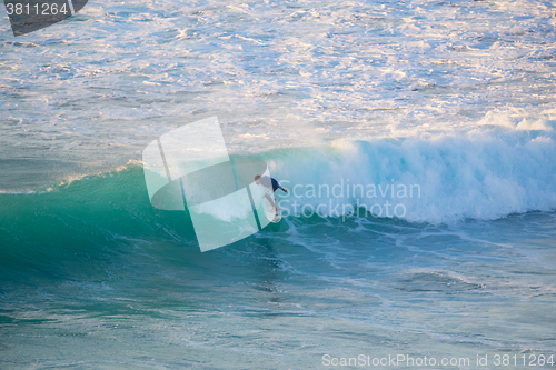 Image of Senior surfer riding a perfect wave.