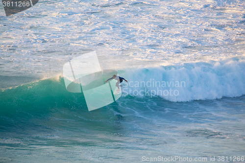 Image of Senior surfer riding a perfect wave.