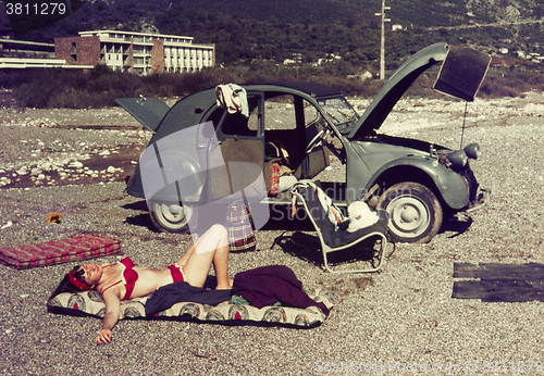 Image of Original vintage colour slide from 1960s, young woman relaxing o