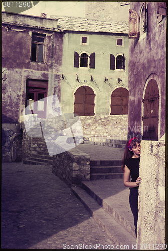 Image of Original vintage colour slide from 1960s, young woman hiding beh