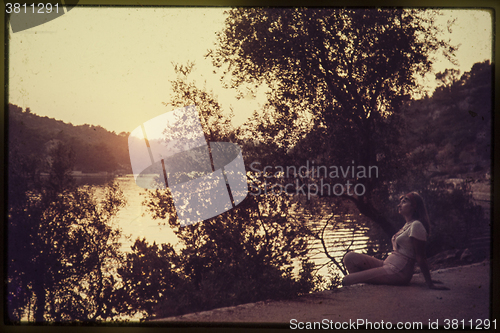 Image of Original vintage colour slide from 1960s, young woman sitting by