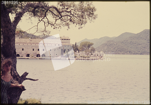 Image of Original vintage colour slide from 1960s, young woman sitting by