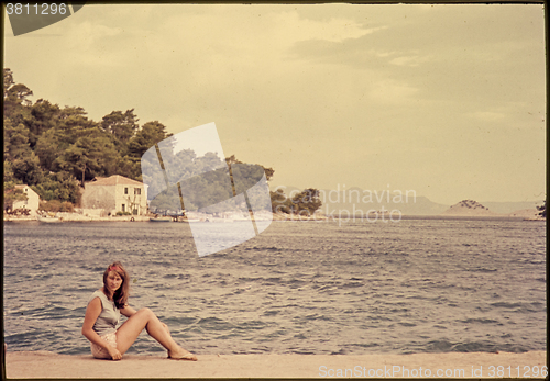 Image of Original vintage colour slide from 1960s, young woman sitting by