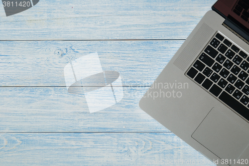 Image of Laptop on a blue wooden desk