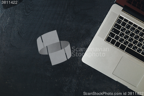 Image of Laptop on the black wooden desk