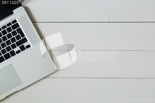 Image of Laptop on the white wooden desk