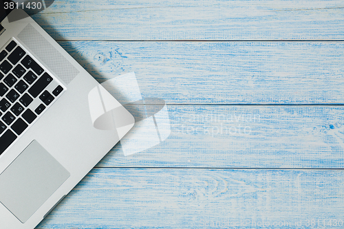 Image of Laptop on a blue wooden desk