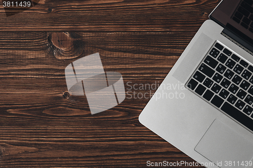 Image of Laptop on the brown wooden desk