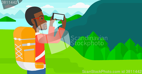 Image of Backpacker taking photo.