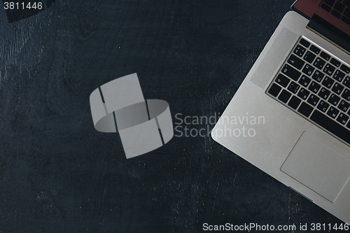 Image of Laptop on the black wooden desk