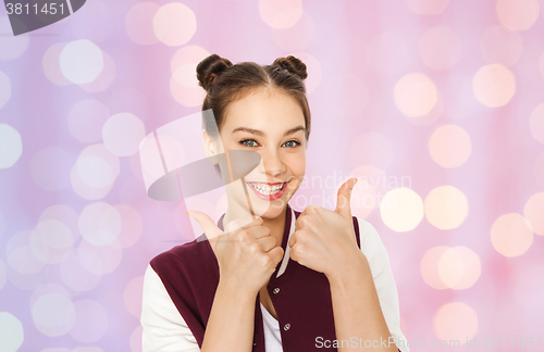 Image of happy pretty teenage girl showing thumbs up