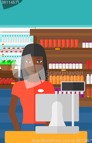 Image of Saleslady standing at checkout.