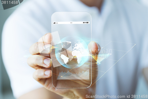 Image of close up of hand with earth globe on smartphone