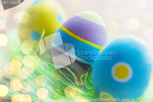 Image of close up of colored easter eggs and grass