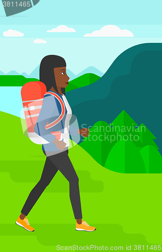 Image of Woman with backpack hiking.