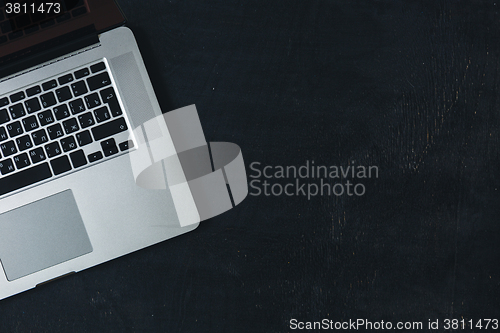 Image of Laptop on the black wooden desk