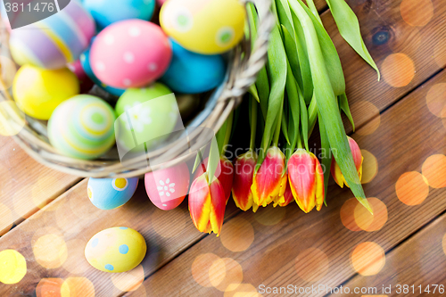 Image of close up of easter eggs in basket and flowers