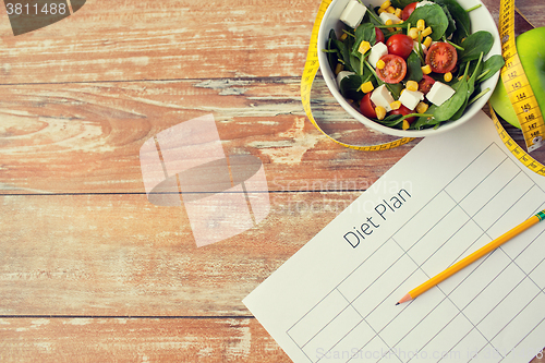 Image of close up of diet plan and food on table