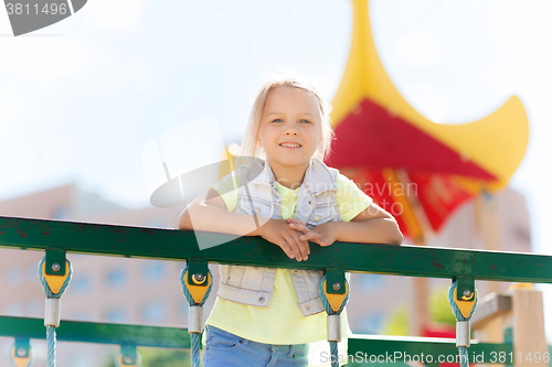 Image of happy little girl climbing on children playground