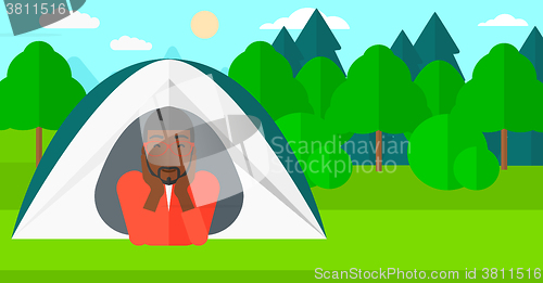 Image of Man lying in tent.