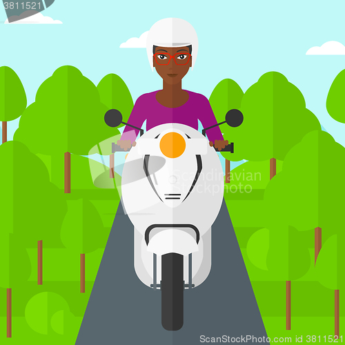 Image of Woman riding scooter.