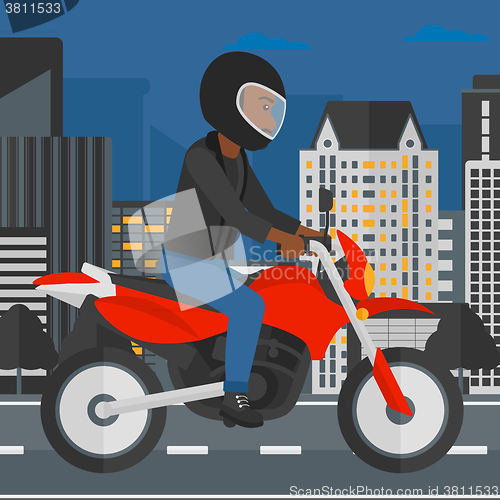Image of Man riding motorcycle.