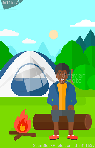 Image of Man sitting at camp.