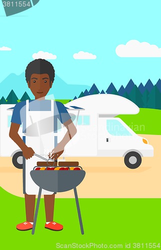 Image of Man preparing barbecue.