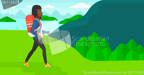 Image of Woman with backpack hiking.