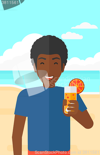 Image of Tourist with cocktail on the beach.