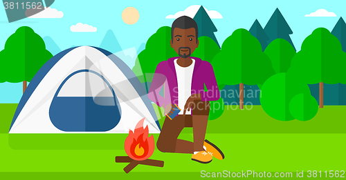 Image of Man kindling fire.
