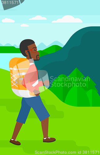 Image of Man with backpack hiking.