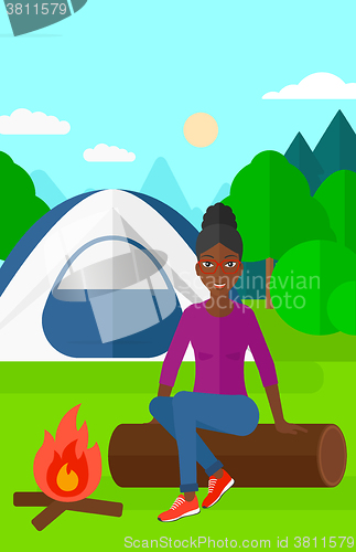 Image of Woman sitting at camp.