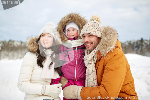 Image of happy family with child in winter clothes outdoors