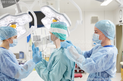 Image of surgeons in operating room at hospital