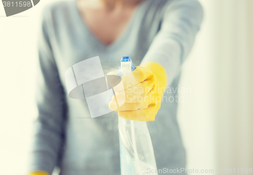 Image of close up of happy woman with cleanser spraying