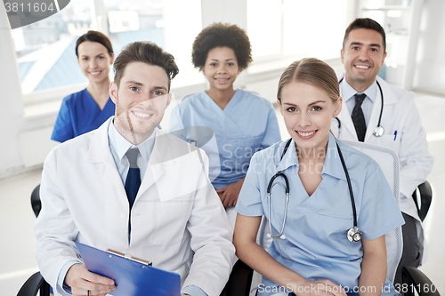 Image of group of happy doctors on seminar at hospital