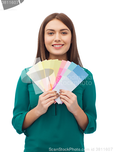 Image of smiling young woman with color swatches