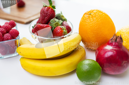 Image of close up of fresh fruits and berries on table