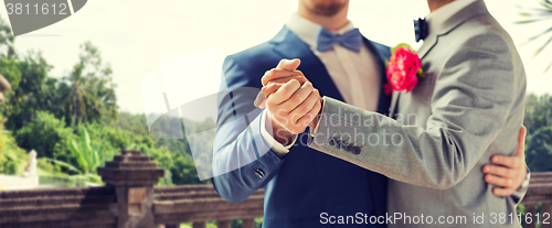 Image of close up of happy male gay couple dancing