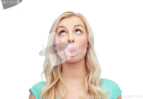 Image of happy young woman or teenage girl chewing gum