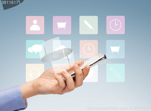 Image of close up of hand with smartphone and menu icons