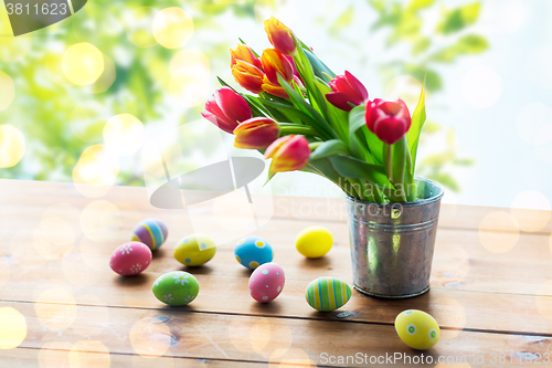 Image of close up of easter eggs and flowers in tin bucket