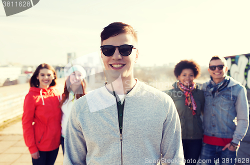 Image of group of happy teenage friends on city street