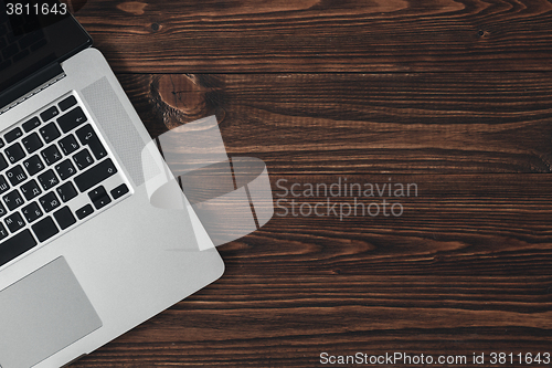 Image of Laptop on the brown wooden desk