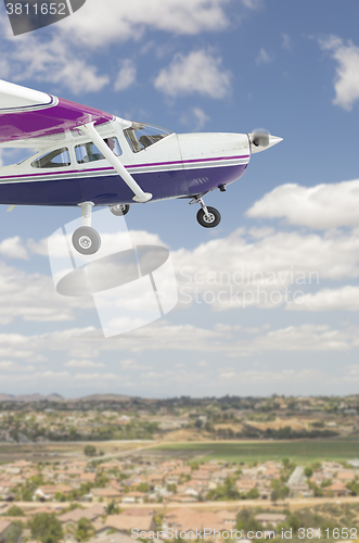 Image of The Cessna 172 Single Propeller Airplane Flying In Sky