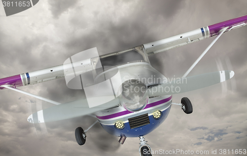 Image of Cessna 172 With Smoke Coming From Engine Against Gray Sky