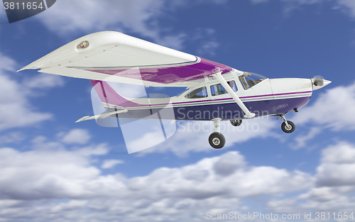 Image of The Cessna 172 Single Propeller Airplane Flying In Sky