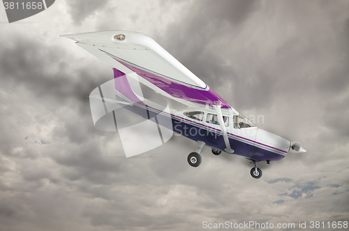 Image of Cessna 172 With Smoke Coming From Engine Against Gray Sky