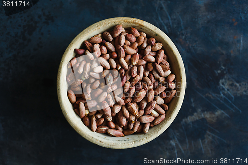 Image of Roasted peanuts in wooden bowl